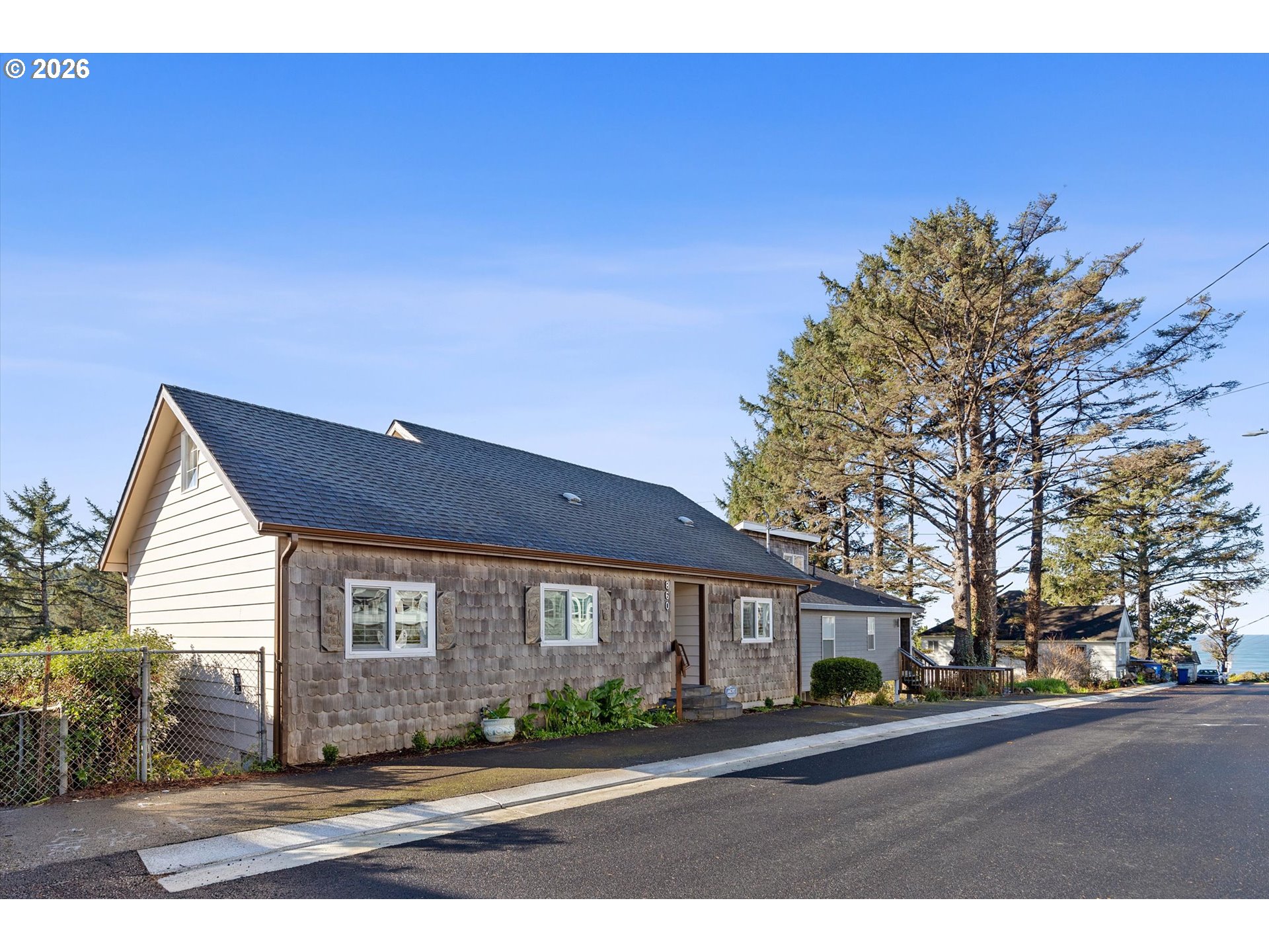 860 Southwest 10th Street Lincoln City, OR 97367 - Photo 42 of 45 a front view of a house with a yard and garage