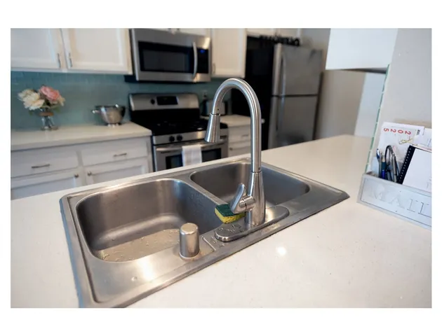 a kitchen with a sink and a refrigerator