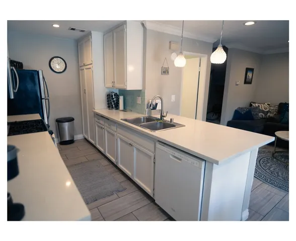 a bathroom with a sink a toilet a mirror and vanity