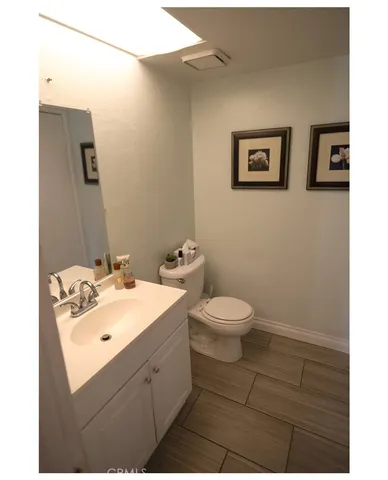 a bathroom with a sink mirror and toilet