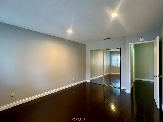 an empty room with wooden floor