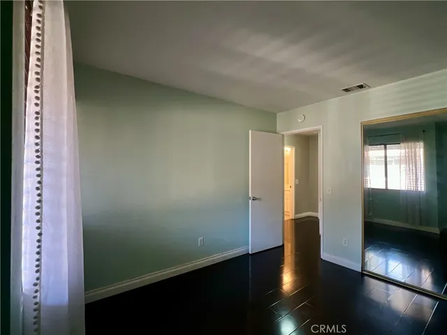 a view of hallway with wooden floor