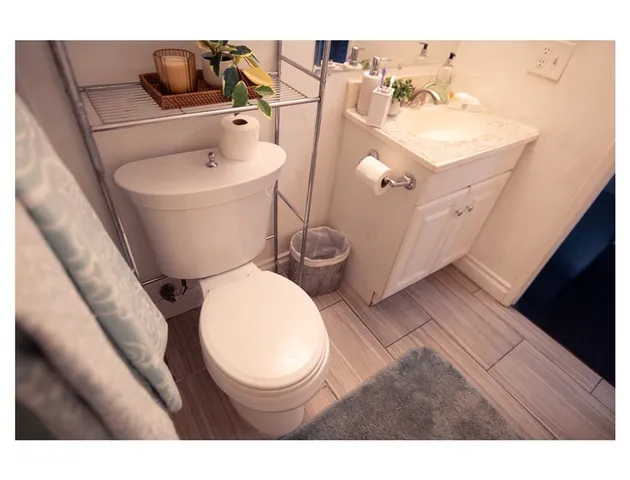 a bathroom with a toilet sink and mirror
