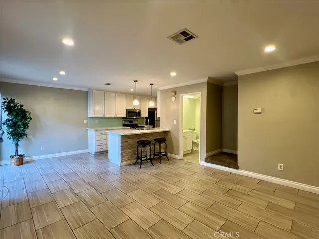 a view of kitchen with kitchen island dining table and chairs