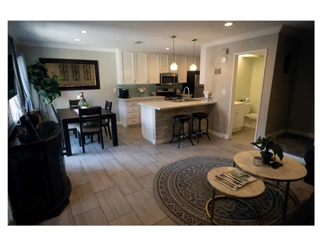 a living room with furniture and kitchen view