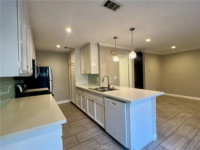 a kitchen with a sink appliances and cabinets