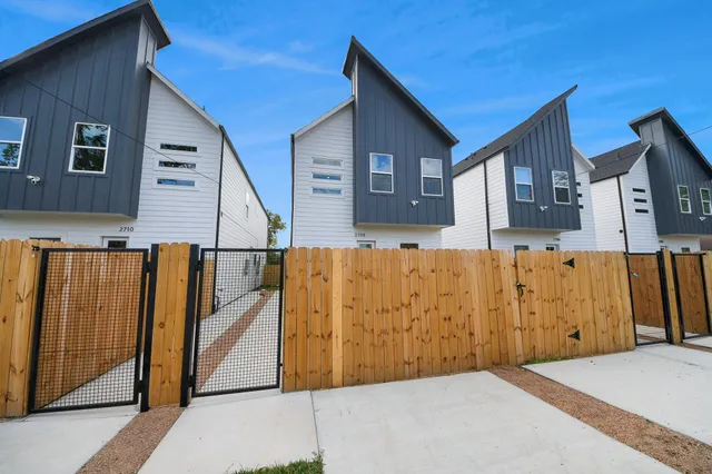 a view of building with wooden fence