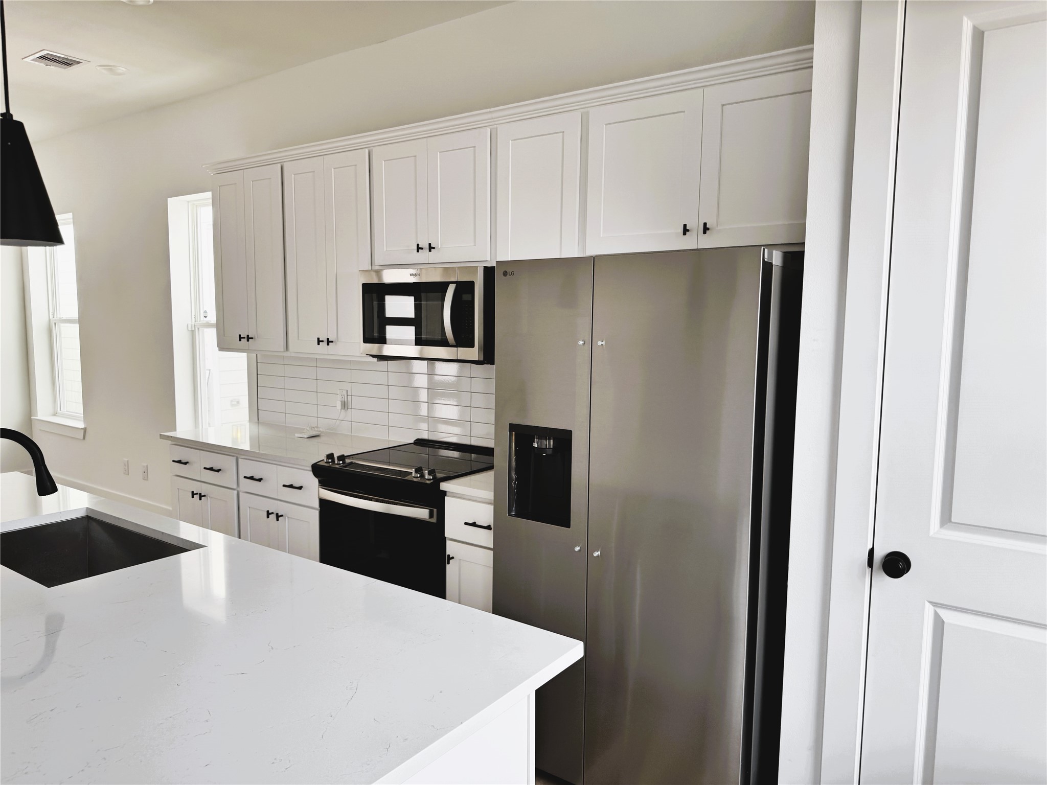 2708 Bostic Street, Unit A Houston, TX 77093 - Photo 5 of 25 a kitchen with granite countertop white cabinets and stainless steel appliances