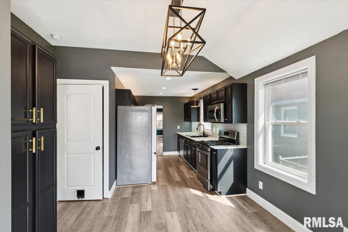 1911 23rd Street, Unit A Moline, IL 61265 - Photo 11 of 28 a view of a kitchen from a dining room