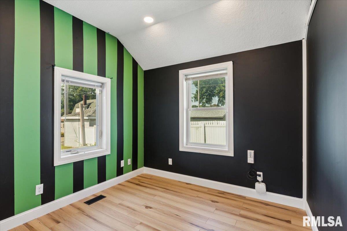 1911 23rd Street, Unit A Moline, IL 61265 - Photo 13 of 28 a bedroom with a bed and a window