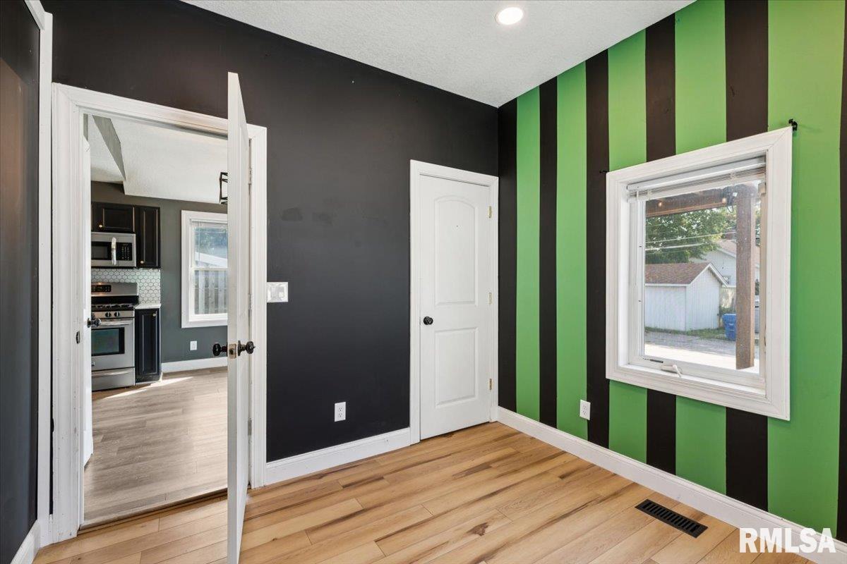1911 23rd Street, Unit A Moline, IL 61265 - Photo 14 of 28 a view of hallway with bathroom and wooden floor