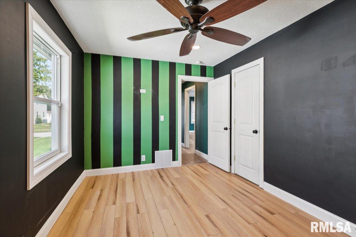 1911 23rd Street, Unit A Moline, IL 61265 - Photo 16 of 28 a view of a room with a large window and wooden floor