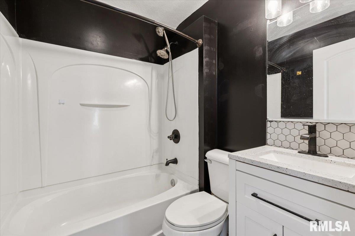 1911 23rd Street, Unit A Moline, IL 61265 - Photo 17 of 28 a bathroom with a sink toilet and shower