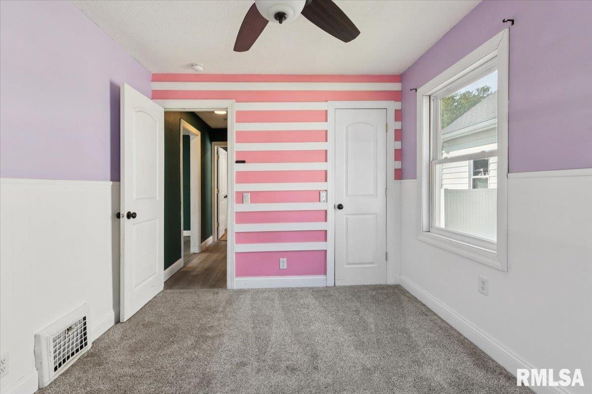 1911 23rd Street, Unit A Moline, IL 61265 - Photo 19 of 28 a view of an empty room with window and cabinet