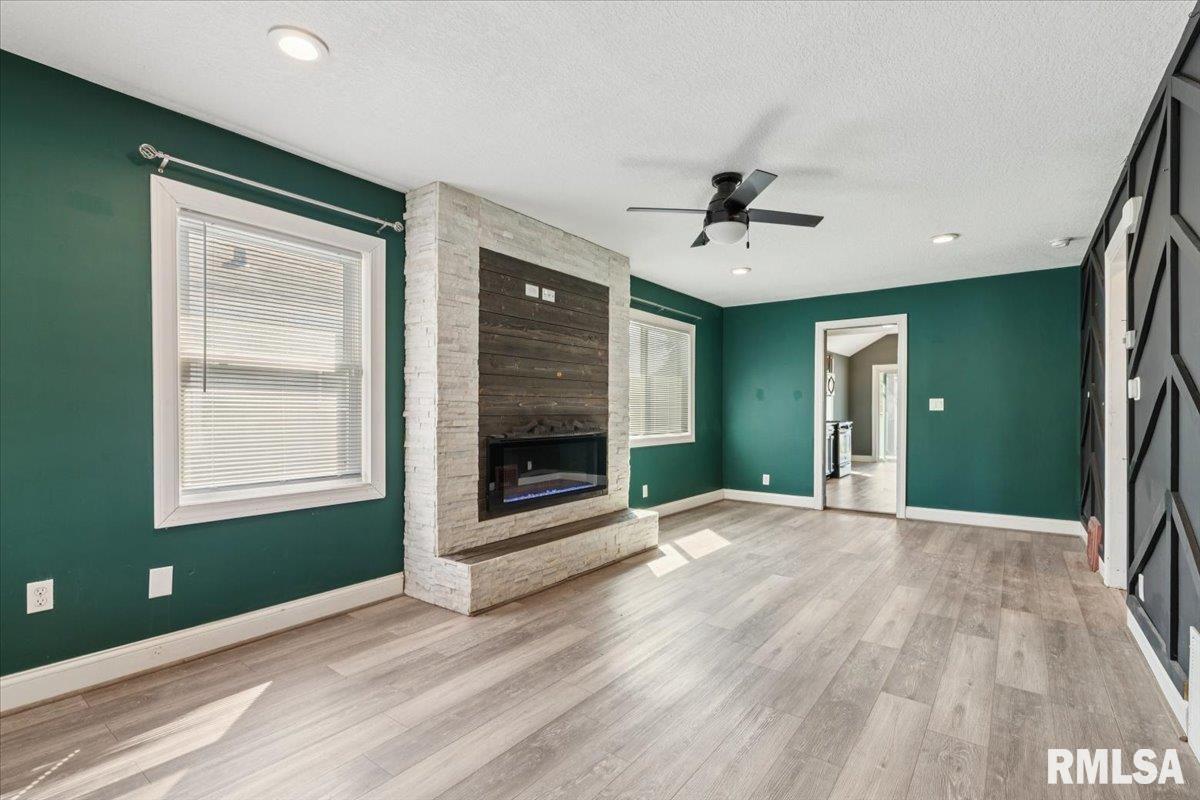 1911 23rd Street, Unit A Moline, IL 61265 - Photo 3 of 28 a view of an empty room with a fireplace and a window