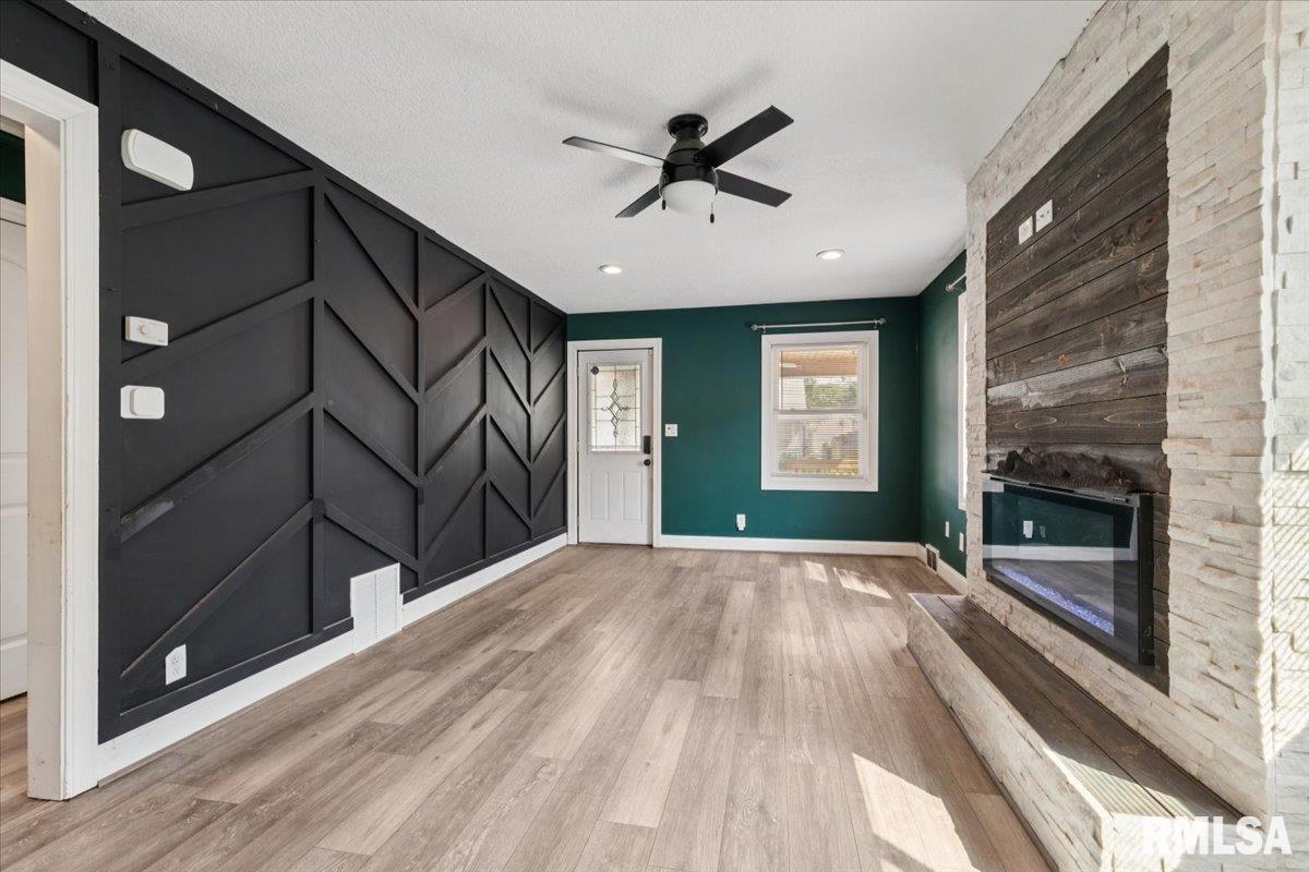 1911 23rd Street, Unit A Moline, IL 61265 - Photo 6 of 28 a view of an empty room with a fireplace and a window