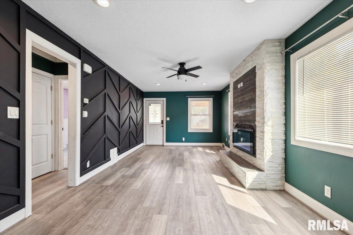 1911 23rd Street, Unit A Moline, IL 61265 - Photo 7 of 28 a view of an empty room with a window and wooden floor