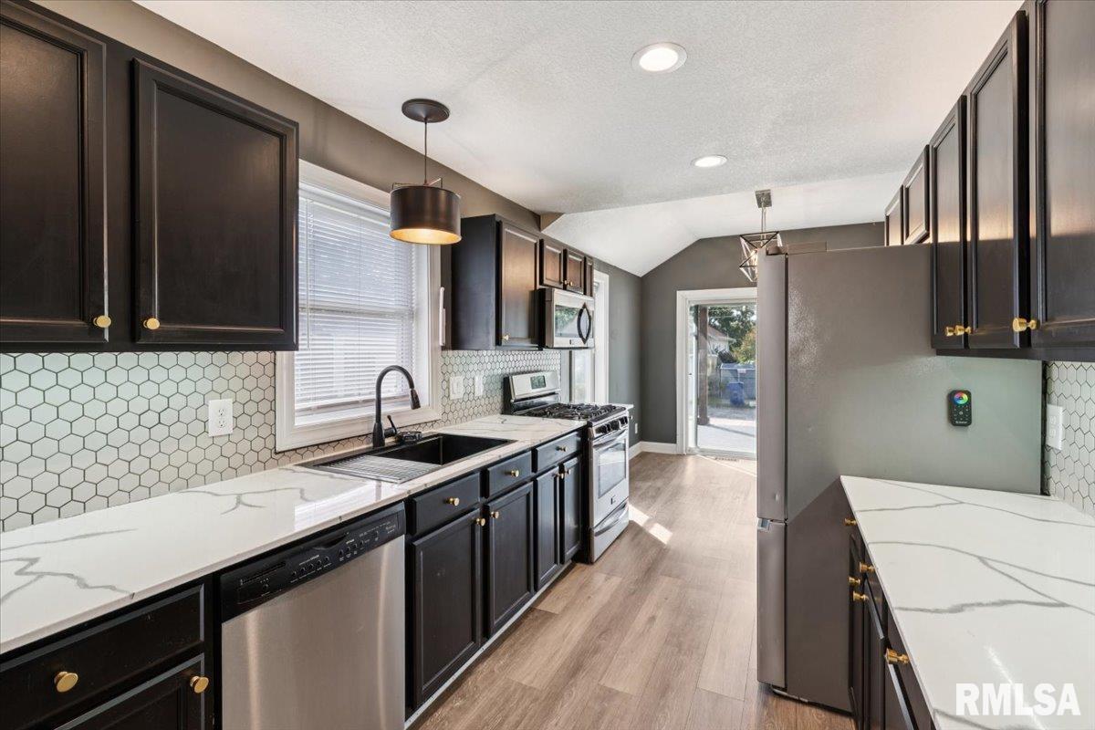 1911 23rd Street, Unit A Moline, IL 61265 - Photo 9 of 28 a kitchen with stainless steel appliances a sink stove and cabinets