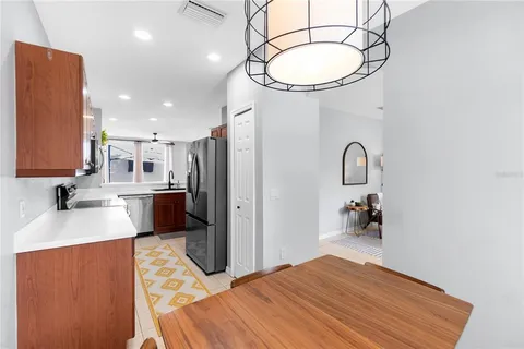 a kitchen with stainless steel appliances a sink cabinets and wooden floor