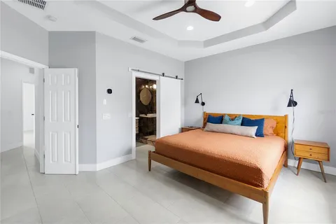 a bedroom with a bed and a chandelier