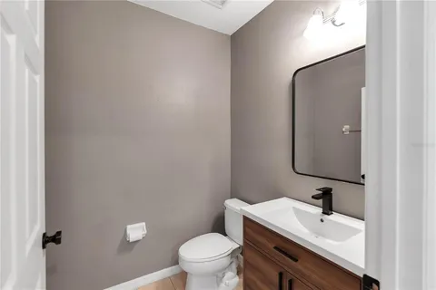 a bathroom with a sink a toilet and mirror