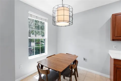 a view of a dining room with furniture and a window