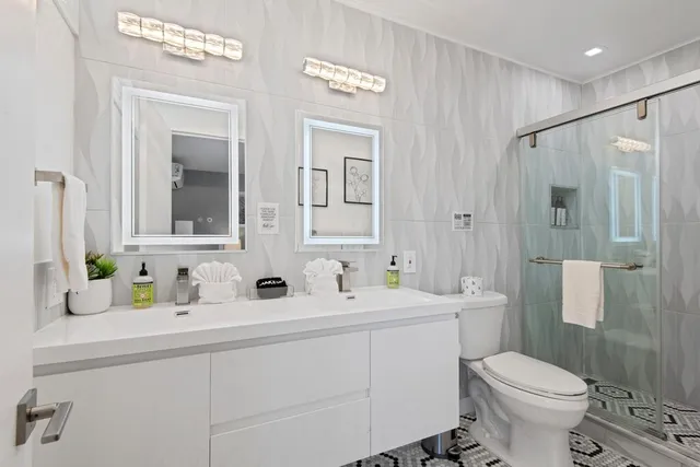 a bathroom with a sink toilet and shower