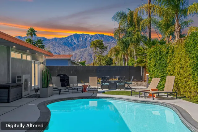 a view of swimming pool with outdoor seating and a patio