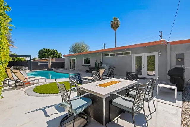 a view of a chairs and table in patio
