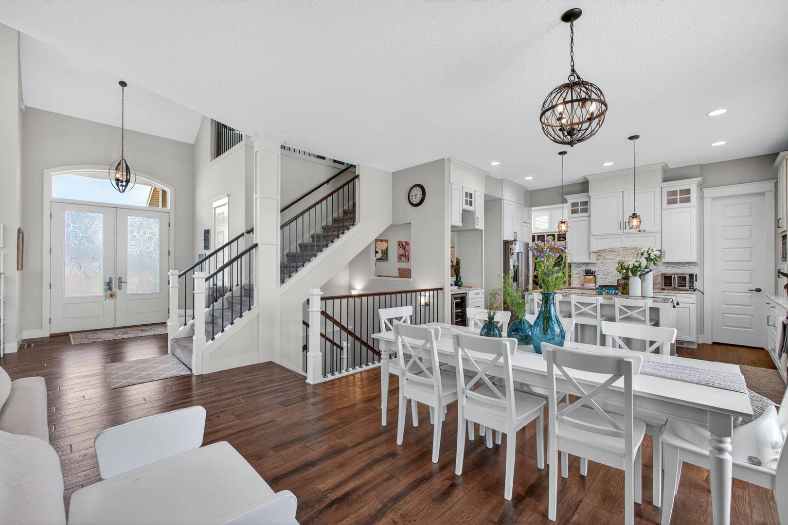 5700 Emily Road Bettendorf, IA 52722 - Photo 11 of 58 a view of a dining room with furniture a rug and wooden floor