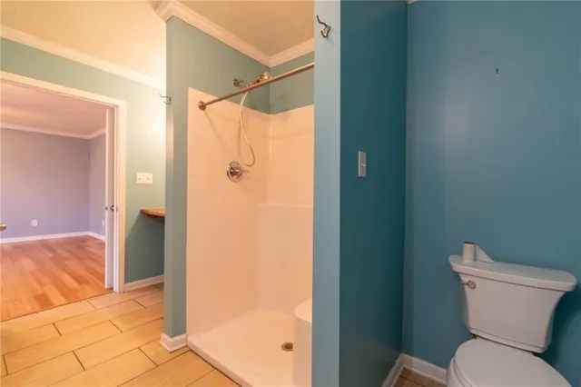 a bathroom that has a glass shower door