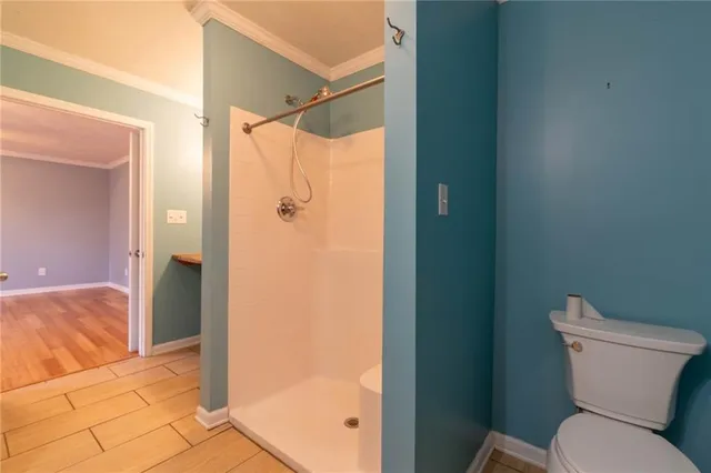 a bathroom that has a glass shower door