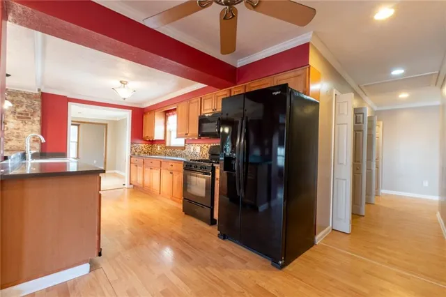 a view of a kitchen with refrigerator and cabinets