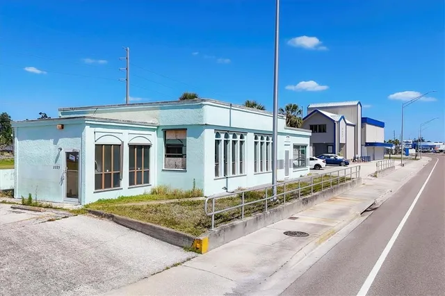 a view of a house with a backyard and balcony