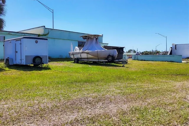 a view of a house with swimming pool and furniture