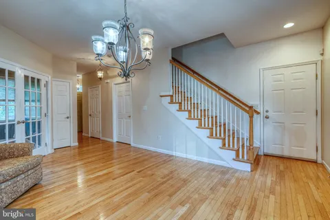 a view of a livingroom with wooden floor and stairs