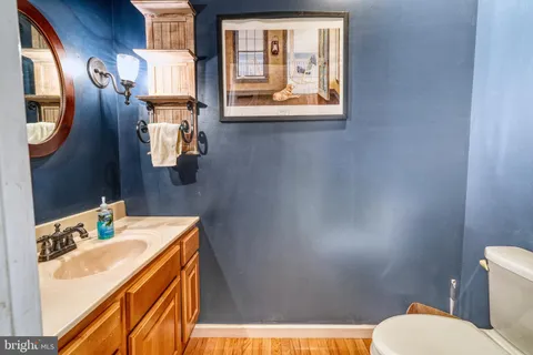 a bathroom with a sink mirror and toilet