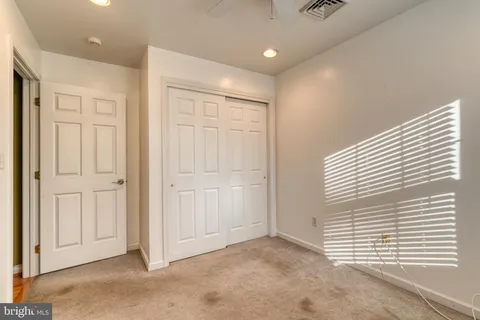 a view of a livingroom with stairs and a ceiling fan