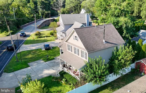 an aerial view of house with yard and swimming pool