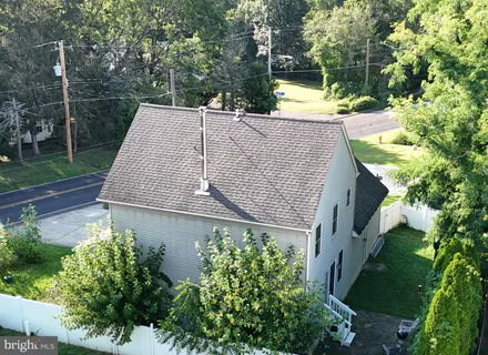 an aerial view of a house with garden space and street view