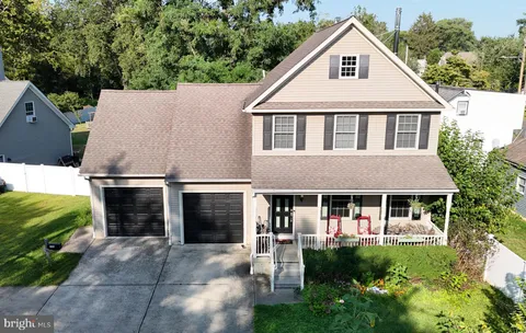 a aerial view of a house with a yard and potted plants