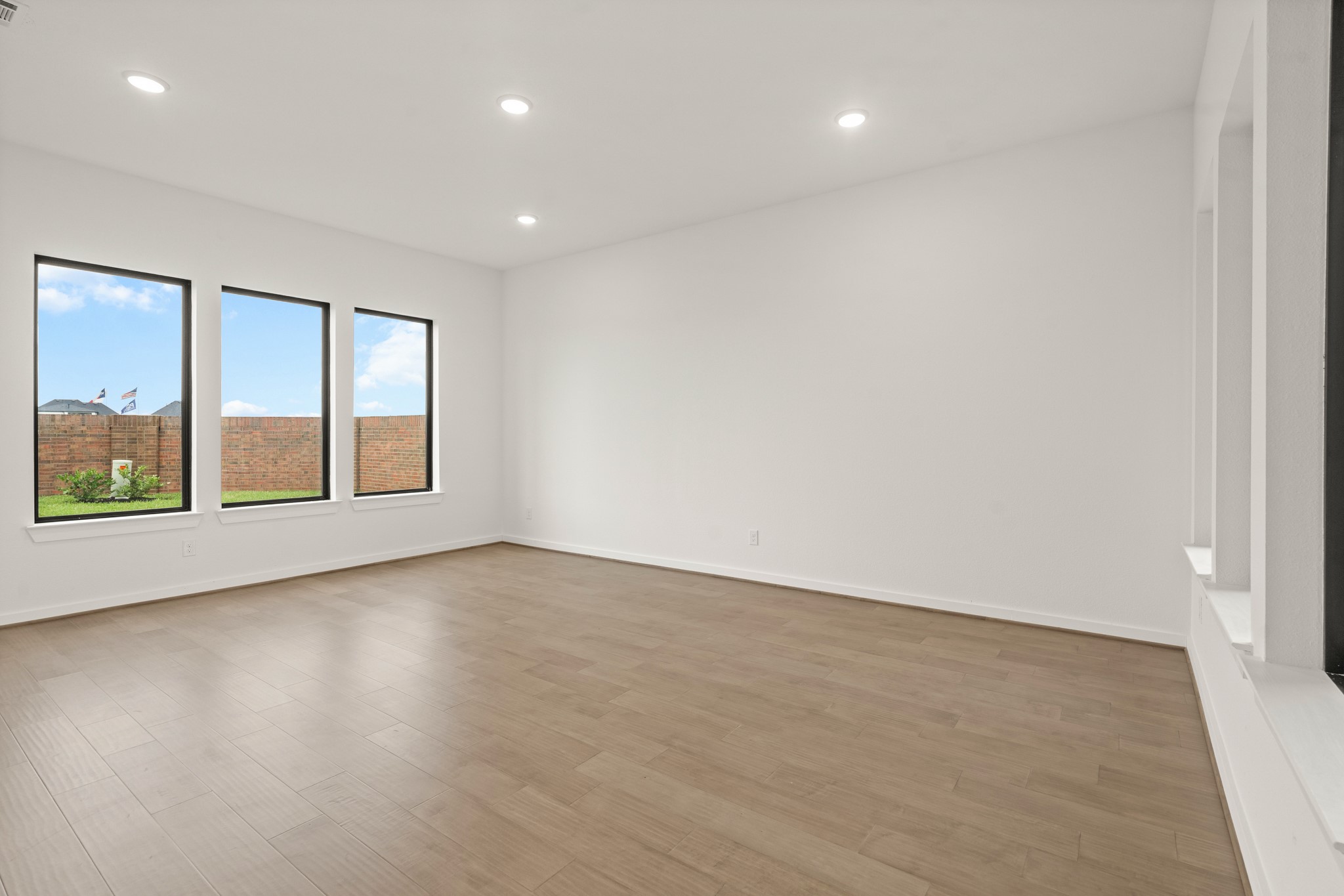 4506 Heather Crossing Road Fulshear, TX 77441 - Photo 5 of 21 *Representational Photo* of the spacious game room that overlooks the backyard on one side and the courtyard on the other.