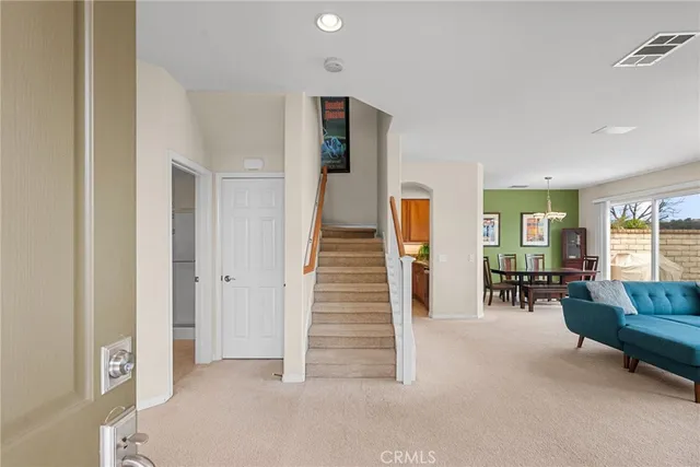 a living room with furniture and a stairs