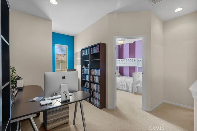 a living room with furniture and a book shelf