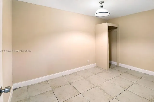 an empty room with sliding door and mountain view