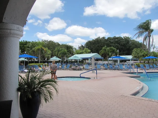 a view of a swimming pool with table and chairs