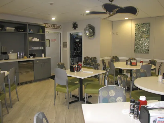 a kitchen with a table and chairs in it