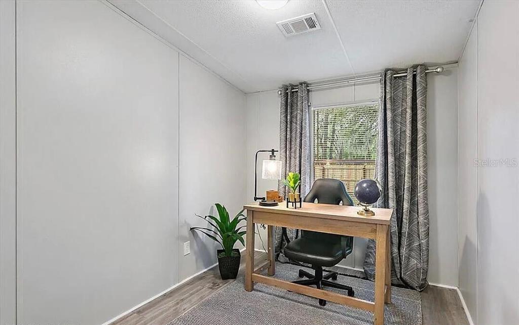 13712 Coman Road Jacksonville, FL 32218 - Photo 13 of 16 a view of a workspace with furniture and a window