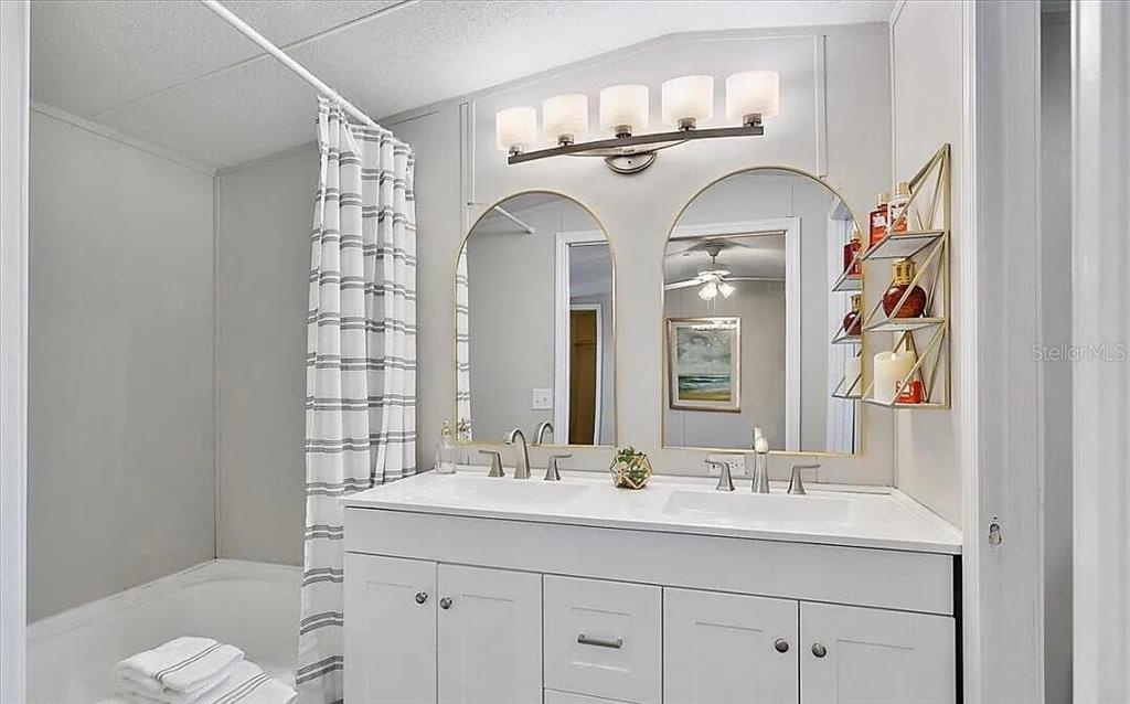 13712 Coman Road Jacksonville, FL 32218 - Photo 15 of 16 a bathroom with a double vanity sink and a mirror