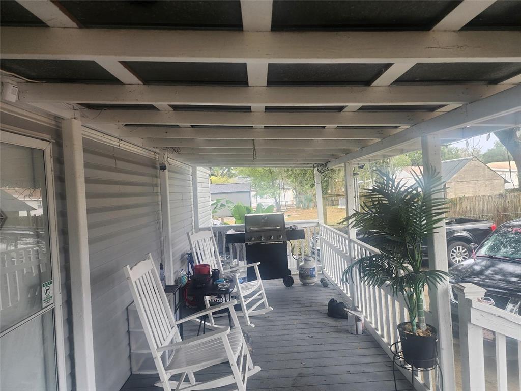 13712 Coman Road Jacksonville, FL 32218 - Photo 6 of 16 a view of a porch with furniture and a yard